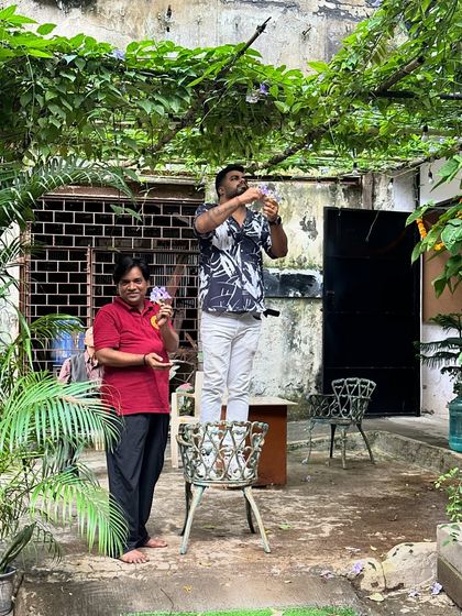 Getting the studio ready for the festivities. Here, we are decorating our outdoor space, hanging lights and ornaments to create a welcoming atmosphere.
