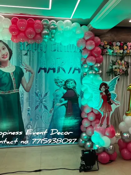 A fairy and Frozen theme combination for a 10th birthday. The decor uses a personalized photo backdrop and cutouts of fairies and Frozen characters.