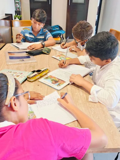 My classes are designed to improve both handwriting neatness and speed, which is very important for students. Here you can see my students practicing diligently to complete their assignments. *Fatafat* they will see a big difference!