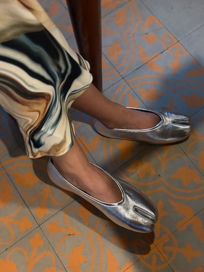 The silver DUPE Tabi flat, perfect for evenings out. The metallic leather catches the light beautifully, adding a touch of unexpected glamour to your look while keeping you comfortable on your feet all night.