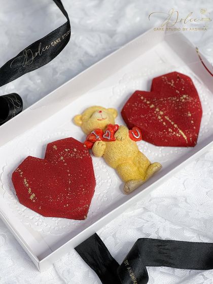 Another view of the Valentine's hamper with two red velvet heart cakesicles and a teddy bear. It's a perfect little box of affection for your special someone.