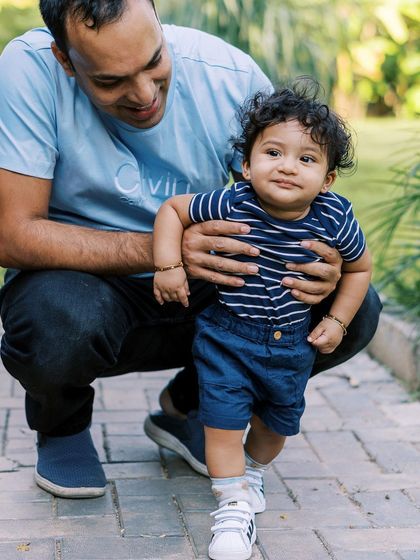 Helping a little one take his first steps is a memory worth saving. I focus on the supportive hands and the proud smiles during these fleeting milestones.