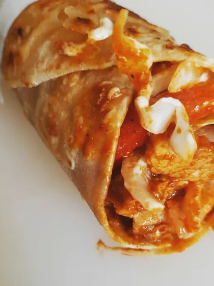 This is our Kundapur Chicken Ghee Roast Roll, a recipe that comes straight from my family's coastal Karnataka roots. The chicken is marinated in pure 'thuppa' or ghee and a secret blend of fiery Kundapuri spices, giving it a sharp, unforgettable punch.