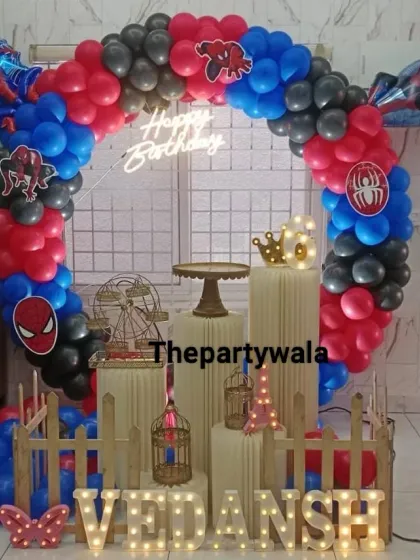 Here is another look at my popular Spiderman theme, perfect for setting up at home. The balloon arch with the neon sign fits perfectly around a TV, and the light-up marquee letters add a special touch.