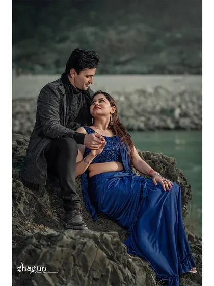 A tender moment shared on the rocks. The way they look at each other tells a story of love and deep understanding, captured in a natural, serene setting.