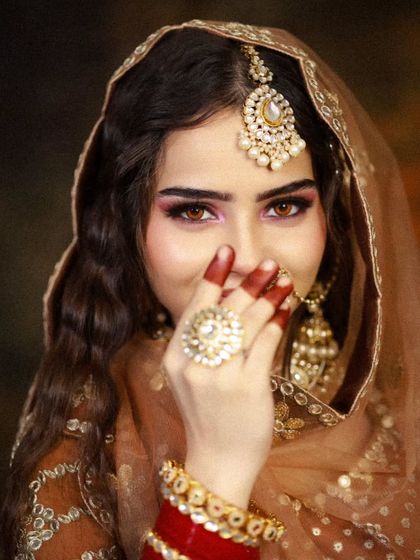 A playful shot that highlights the bride's personality and the beautiful henna on her hands.