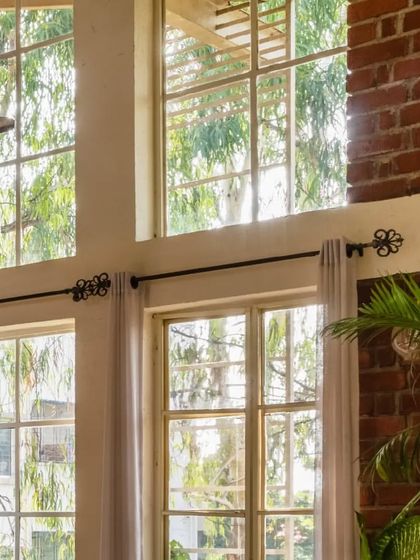 Amidst the exposed brick, these large, white filigree windows provide a natural burst of color and light. They extend the view to the surrounding greenery, filling the space with 'pawsitivity'!