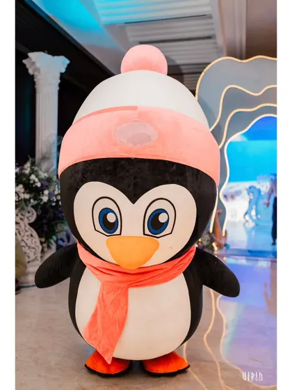 A friendly penguin mascot greets guests at the 'Under the Sea' party. Mascots are a wonderful way to delight children and bring the party's characters to life.