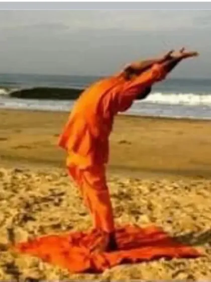 Practicing Surya Namaskar (Sun Salutation) on the beach. Connecting the practice with the elements of nature amplifies its energy and benefits.