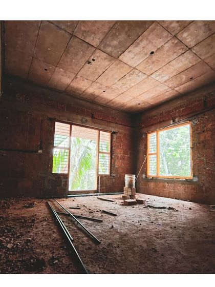 A room under construction, with window frames installed. Even at this raw stage, the placement of openings is crucial for framing views of the surrounding nature and bringing in natural light.