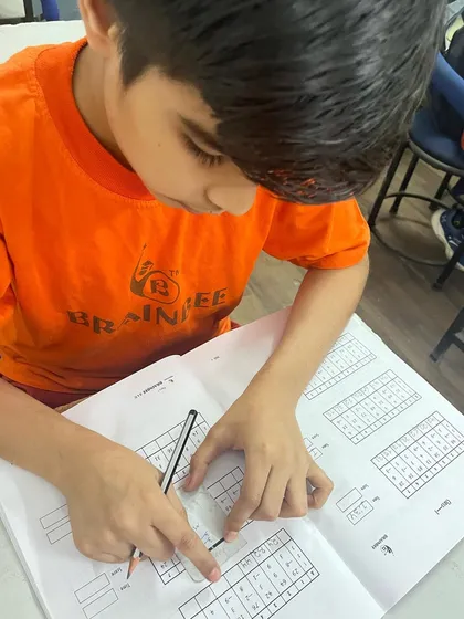 A quiet moment of intense focus. This image captures one of our students deeply engaged in his workbook, practicing the techniques that build speed, accuracy, and concentration.