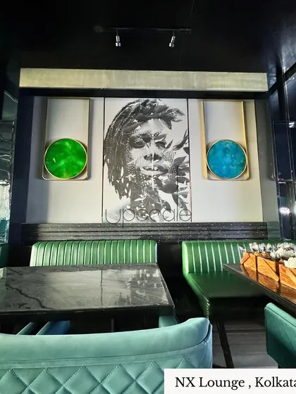 For the NX Lounge in Kolkata, we created a moody and artistic atmosphere. The design features a masculine grey backdrop, dramatic art, and vibrant emerald and cobalt seating to infuse the space with dynamic energy.