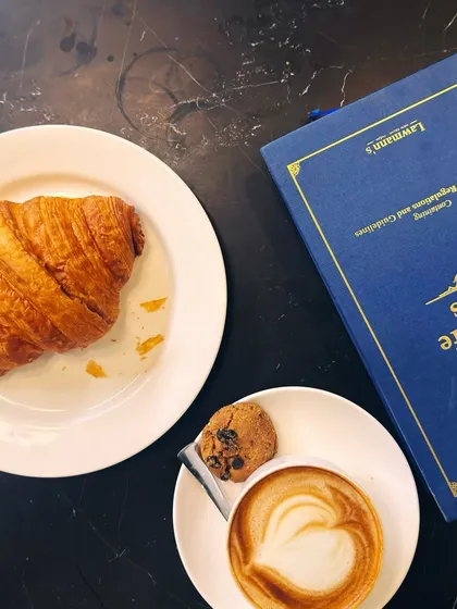 A perfect combination: coffee, a croissant, and a book on Forest and Wild Life Laws. My work is my passion, and it's always on my mind.