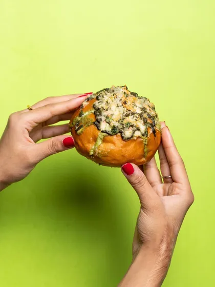 This is my Pesto Cream Cheese Bun, a delicious twist on the classic. It's filled with the same creamy goodness but with an added layer of fresh, herby pesto.