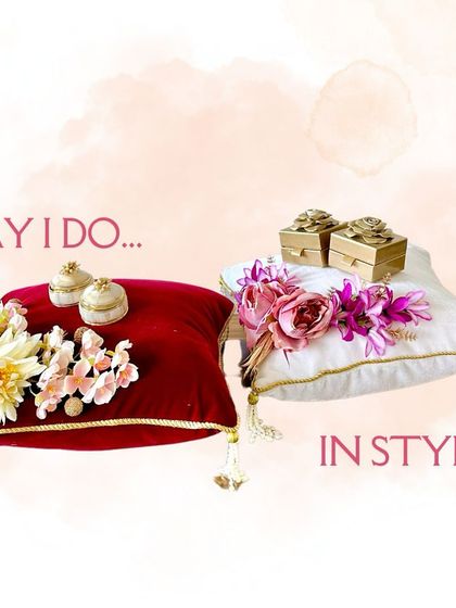 A closer look at my classic ring platter designs. The deep red and pristine white cushions are decorated with artificial flowers and elegant ring holders, offering a timeless choice for any engagement.