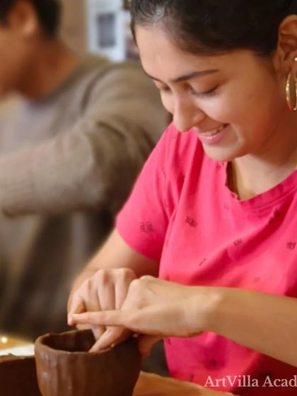 A student smiles as she refines the shape of her hand-built cup. Our workshops are a great way to learn a new skill while enjoying the vibe of a local taproom.