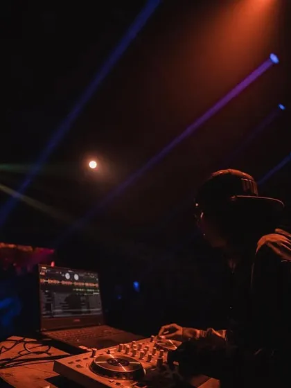 In the zone during a live show, with the stage lights cutting through the dark. This is the focus it takes to deliver a flawless set.