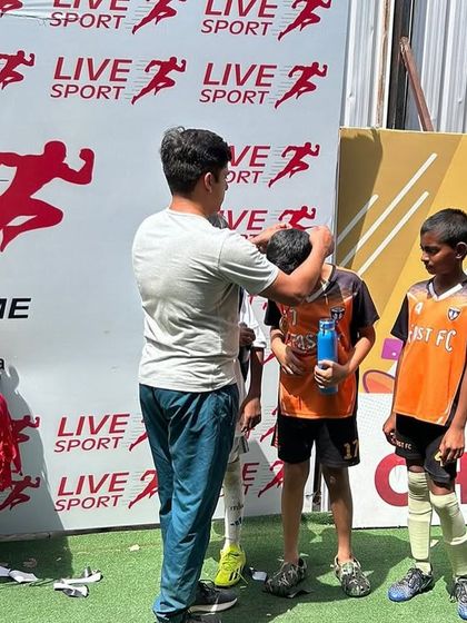A player from our U11 semi-finalist team receives his medal for a spirited performance.
