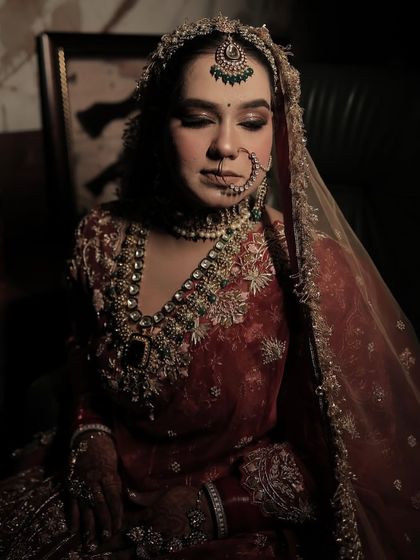 Another stunning, professionally shot photo of my bride. The makeup focuses on defined, smoky eyes and a matte base, creating a very regal and almost vintage bridal portrait.