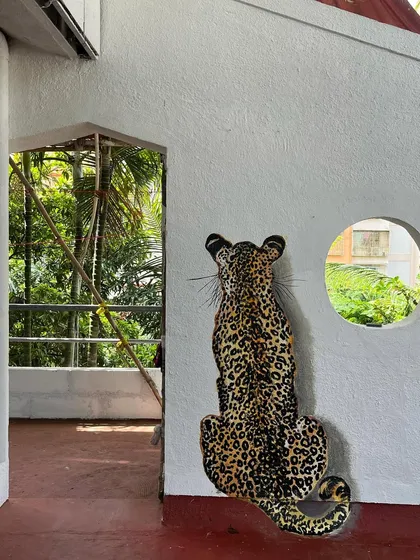 The way the leopard is positioned next to the doorway makes for a fun surprise.