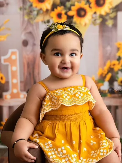A bright and cheerful portrait from a sunflower-themed session, showcasing the vibrant backdrops and adorable outfits I provide.
