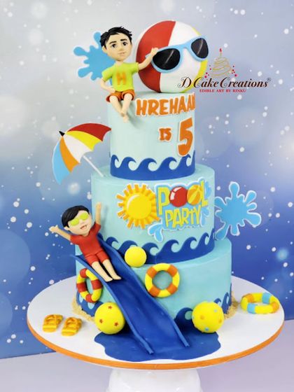 A three-tier pool party cake for Hrehaan's 5th birthday. This elaborate design features a water slide, lifebuoys, and two boys ready to make a splash.