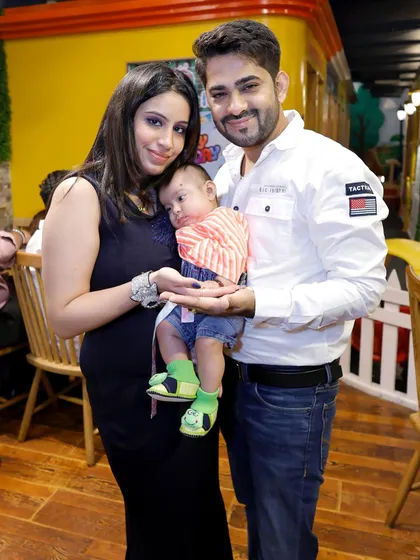 A beautiful young family posing for a photo at a party. These are the moments that matter.