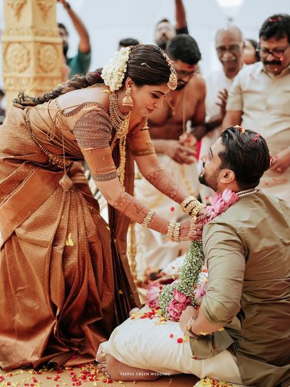 The bride places the garland on the groom, a joyful and significant moment in their Hindu wedding ceremony.