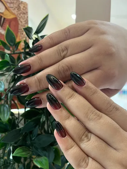 Another view of the black and red ombré nails, showing the seamless blend of the two dark, powerful colors.