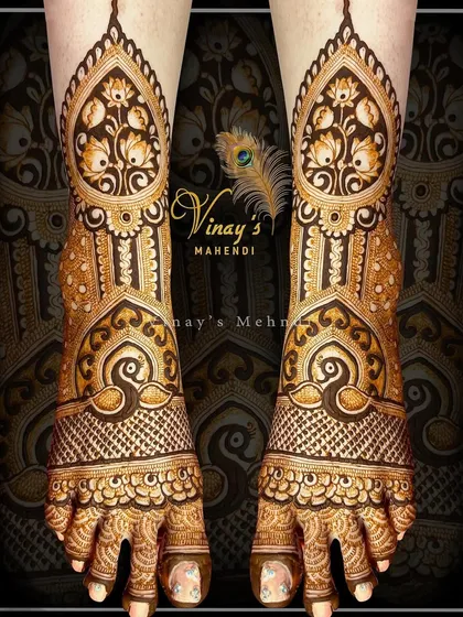 A classic bridal foot design with large lotus and peacock motifs. The pattern is dense and rich, perfect for a traditional bridal look.