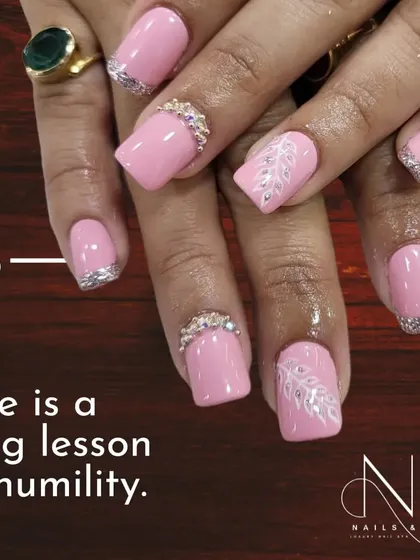A bold and beautiful pink set. We used a square nail shape and added sparkling silver tips and intricate rhinestone bands for a look that is pure glamour.