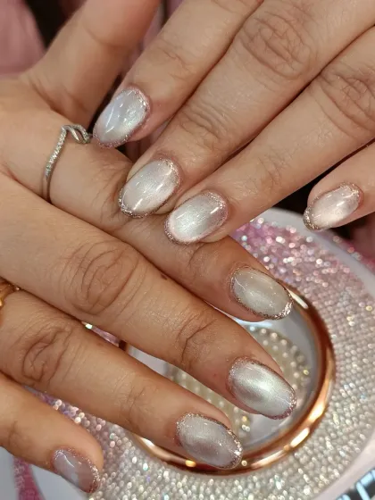 A close-up shot showcasing the flawless application of the cat-eye gel and the precise glitter work around the cuticles.