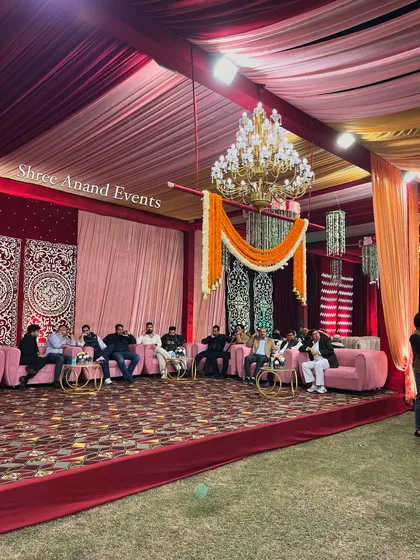 A dedicated lounge area with plush pink sofas set against an ornate backdrop, providing a comfortable space for guests.