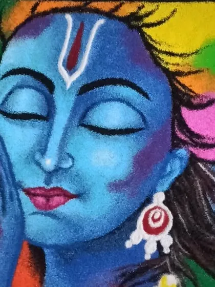 A close-up on Lord Krishna's face from my portrait rangoli. You can see the delicate shading on the cheek and the serene expression, all achieved with powdered colors.