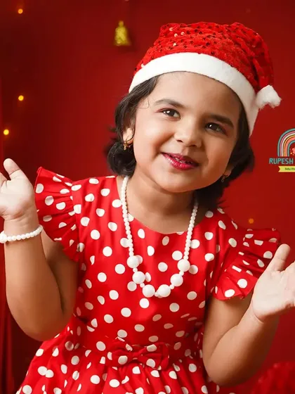 A beautiful portrait of a little girl in her Santa hat, ready to celebrate the season with a sweet smile.