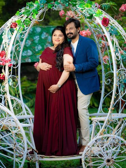 A sweet maternity moment by the Cinderella carriage, a perfect fairytale setting.