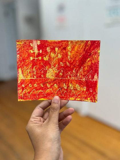 A fiery abstract piece made by a young student using the sgraffito technique with oil pastels. This method involves scratching away a top layer of color to reveal another underneath.