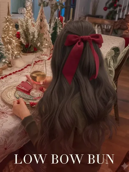 A low bow bun is the epitome of effortless elegance. This simple, classic style is elevated with a large velvet bow, making it a perfect choice for a sophisticated holiday dinner or New Year's Eve party.