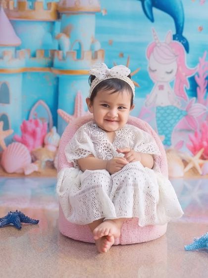 A happy little mermaid with the sweetest smile. Her joy brings this enchanting underwater-themed photoshoot to life.