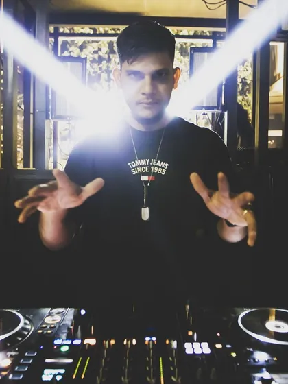 A fun shot of me "playing the air piano" over my decks, showing my playful interaction with the music.