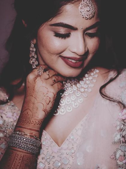 A graceful portrait of the bride, highlighting her intricate henna and sparkling wedding jewelry.