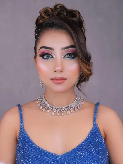 A full-face view of the blue and pink party look, highlighting the glowing skin and the overall glamorous effect.