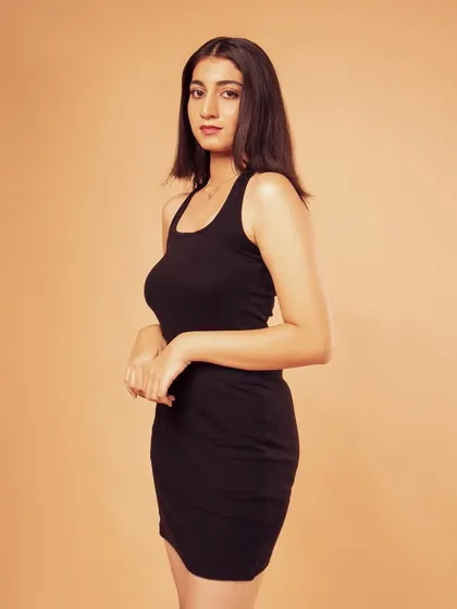 A three-quarter shot of the little black dress. The pose is simple and elegant.
