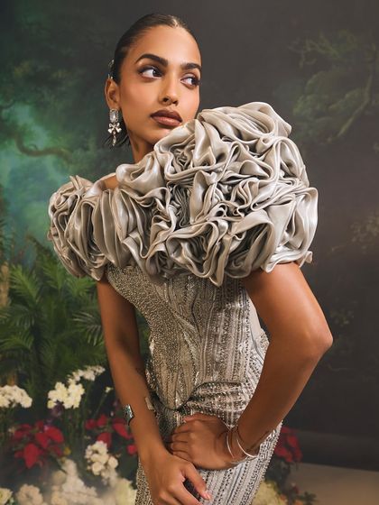 A close-up of the Bellerose Gown's 3D cape, showcasing the artistry and texture of the hand-sculpted roses that define this unforgettable piece.