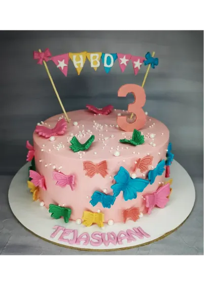 A cheerful butterfly cake for a 3rd birthday. This fresh pineapple cake is covered in colorful handmade fondant butterflies and a cute birthday banner.