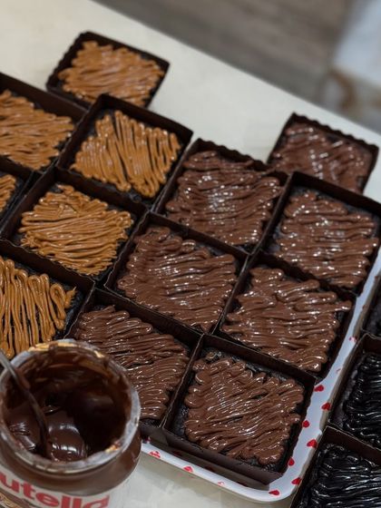 Getting our Rakhi brownie orders ready. This tray shows our Nutella and Biscoff topped brownies, a popular choice for gifting.