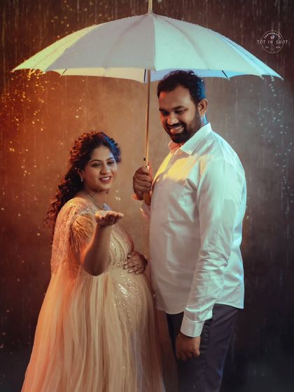 A playful moment in our studio rain setup, as the mom-to-be reaches out to "feel" the drops.