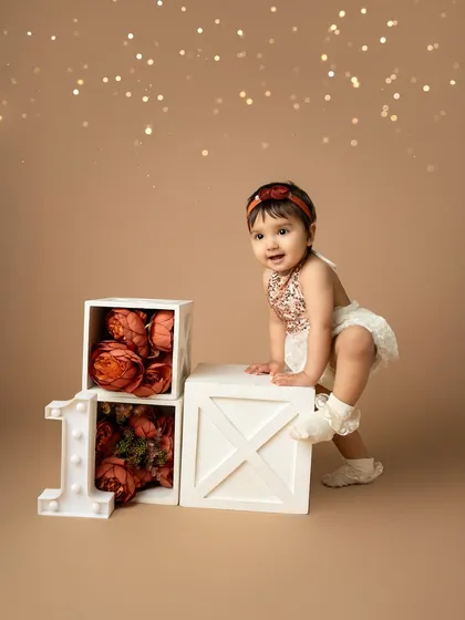 Almost ready to make a move. This first birthday portrait captures the excitement and curiosity of a one-year-old exploring her special birthday set.