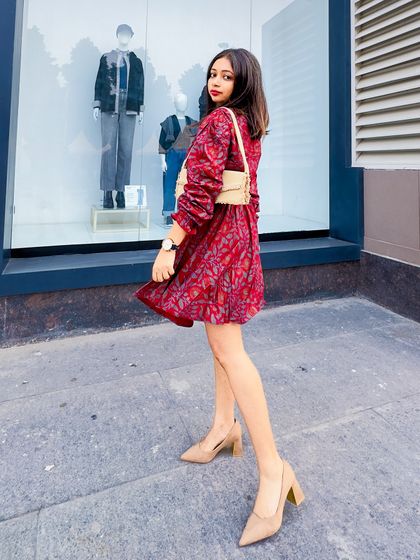 A side view of the preppy red printed dress. The puff sleeves and A-line skirt create a very feminine silhouette.