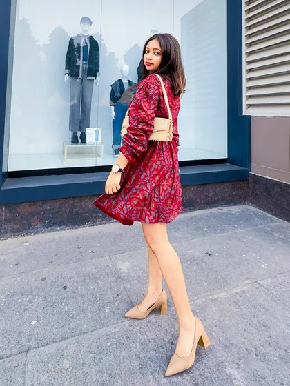 A side view of the preppy red printed dress. The puff sleeves and A-line skirt create a very feminine silhouette.